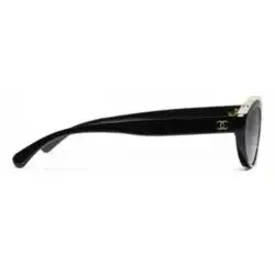Shop Chanel CH5416 C1711S9 Polarized Oval Sunglasses featuring a black acetate frame with translucent ivory detailing, grey polarized lenses, Category 3 protection,